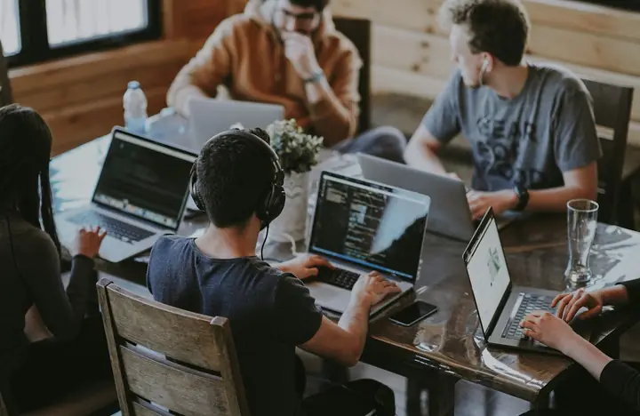 A team working together on laptops around a table